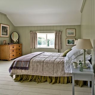 bedroom with wooden wall and wooden flooring