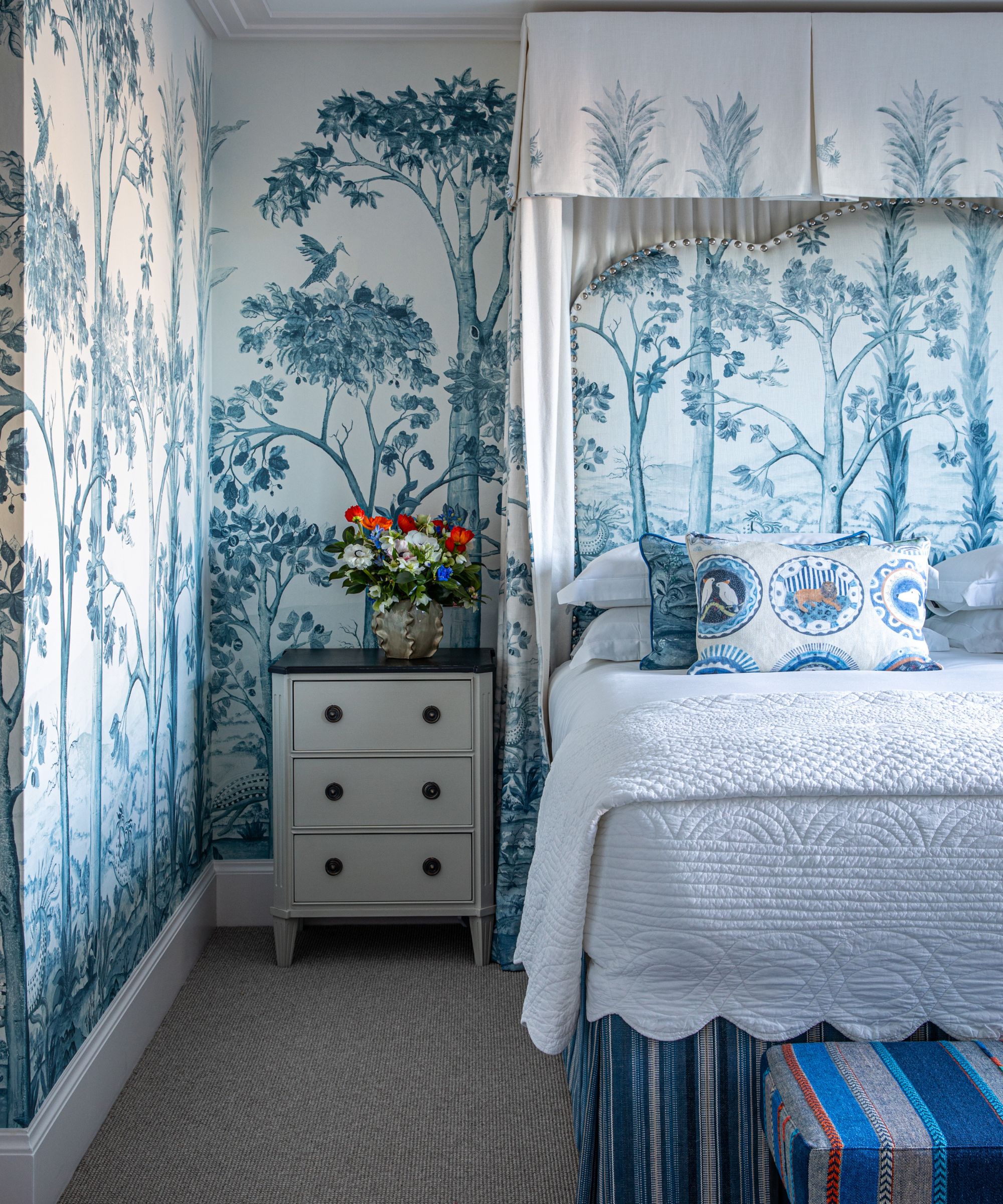 canopy bed with mural wallpapered walls in blue and white