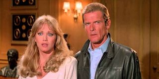 A View To A Kill Tanya Roberts and Roger Moore looking confused in an office