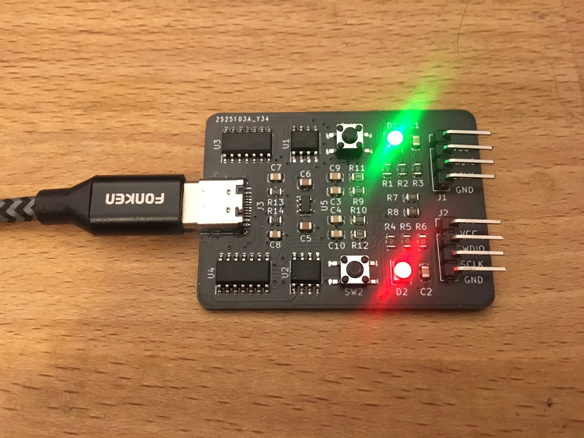 A cursed USB-C board with green and red LEDs