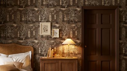 Graham &amp; Brown wallpaper of the year 2025 in bedroom with brown door and wooden furniture