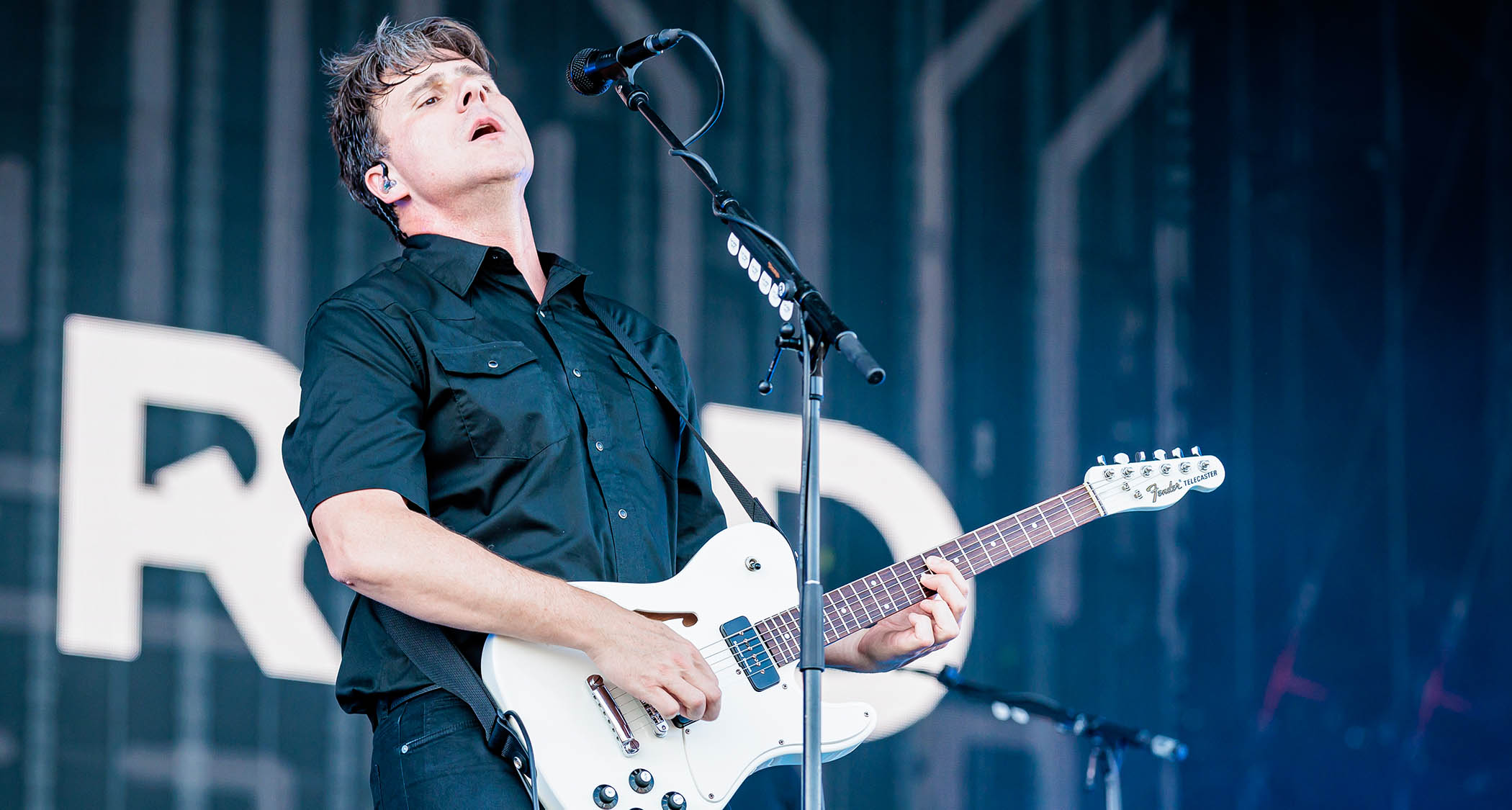 Jim Adkins of Jimmy Eat World plays an open-air show in Italy, 2025, with his signature Telecaster in white.