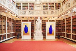 Interior view of palace library and two blue statues