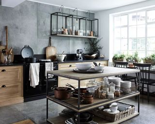 A grey kitchen by Neptune using two stacked coffee tables as island and upturned nest tables as shelves