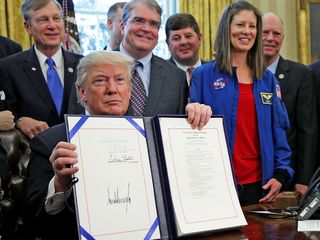President Trump signed the NASA Transition Authorization Act of 2017 on March 21, 2017, surrounded by members of Congress and two NASA astronauts.