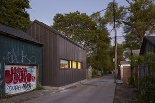 Laneway house by LGA Architectural Partners. A modern looking house built in a lane surrounded by older houses.