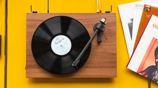 Pro-Ject T2 Super Phono on a yellow background