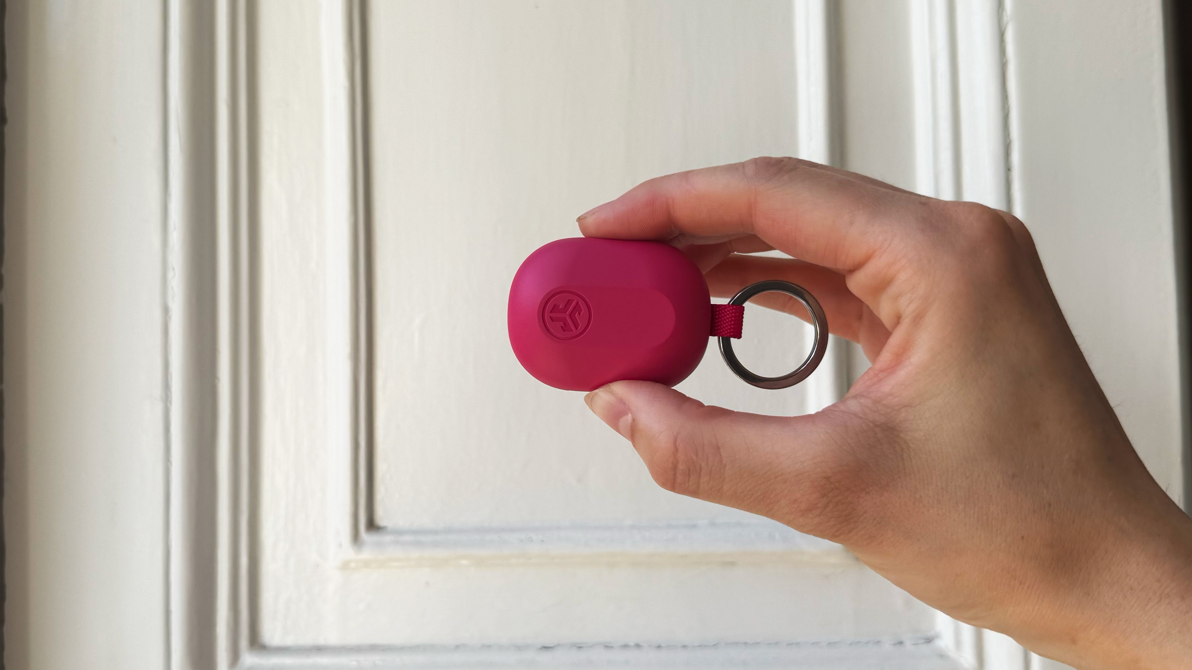 the jlab jbuds mini charging case in hot pink against a white background