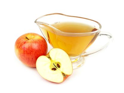 Apple Next To A Glass Of Apple Cider Vinegar