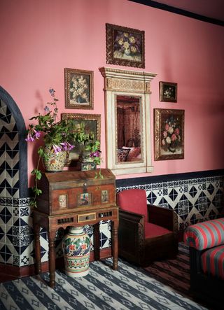 Pink walls with black and white tiled wall panelling