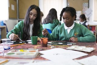Two children doing art in school as plans for extended school day are revealed for the UK
