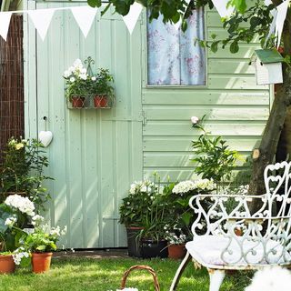 white door house garden plants and chair