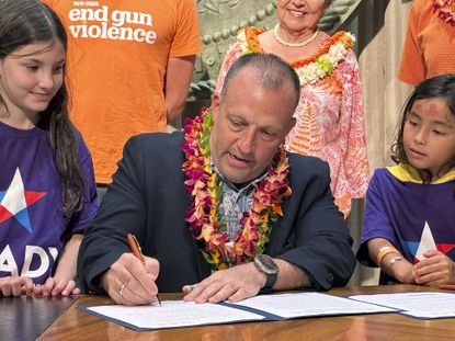 Hawaii Gov. Josh Green (D) signs gun control legislation. 