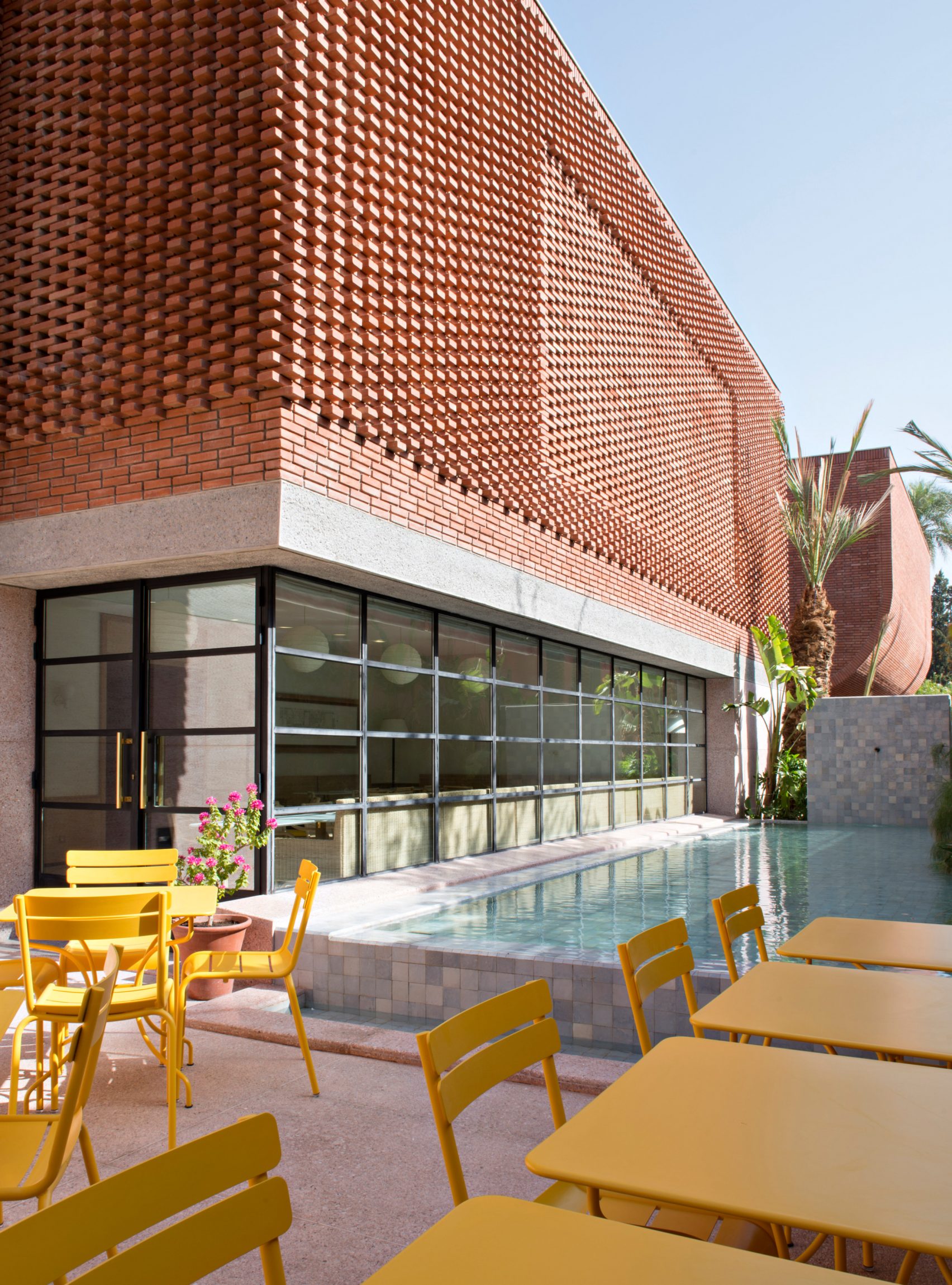 A design-forward museum features a brick-clad exterior and an airy, light-filled sculptural interior.