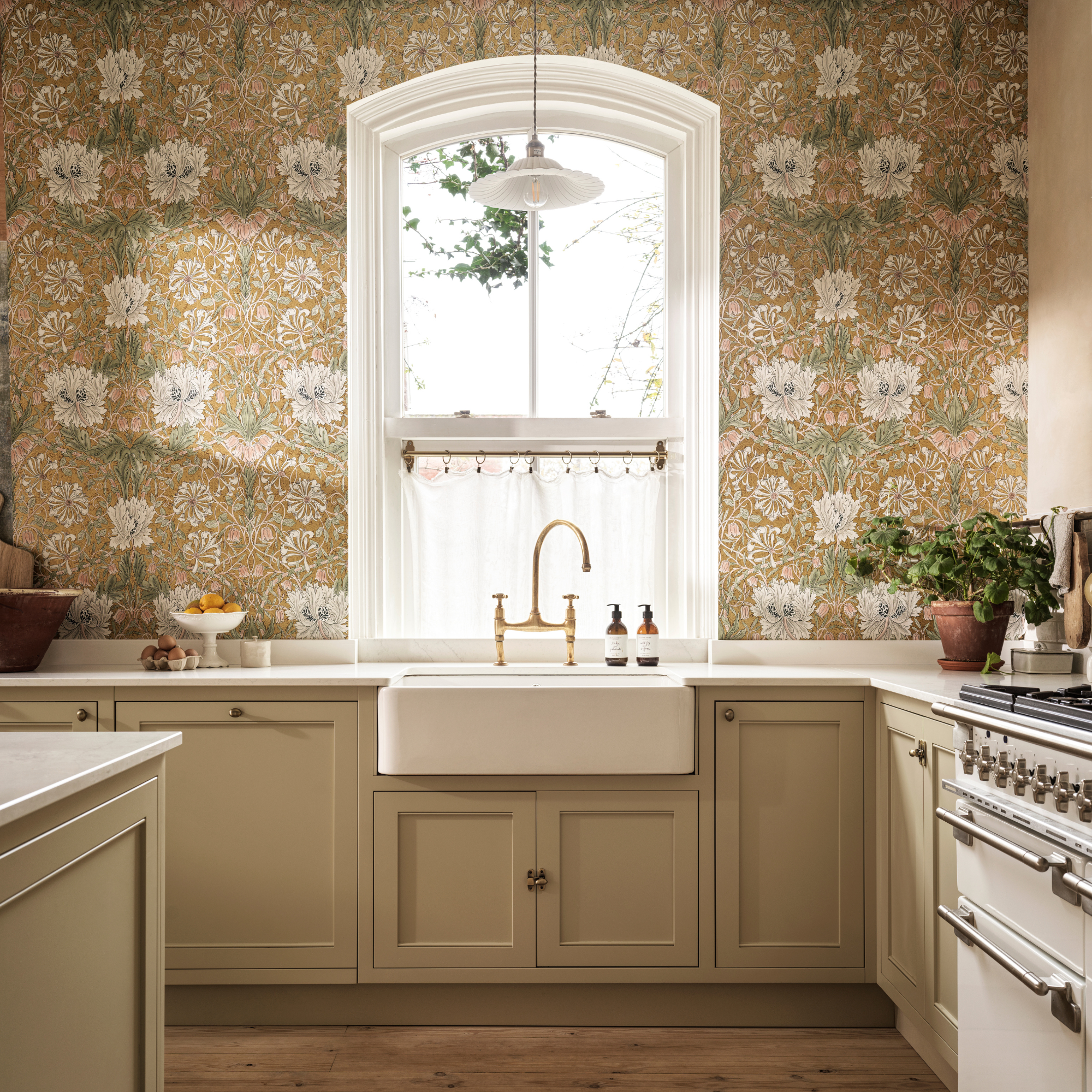 a william morris print wallpaper in a cream kitchen
