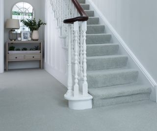 light grey carpet in hallway with stairs