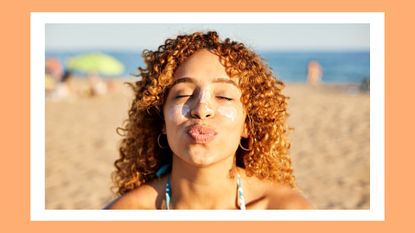 Summer solstice 2023: meaning, how to embrace it and more. Pictured: Smiling happy woman applying sunscreen to her face on the beach at sunset