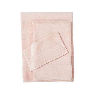 Three folded peach colored towels