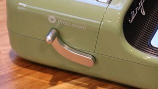 Niimbot B21 review; a small green label printer on a wooden table