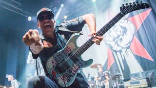 Tom Morello playing his Arm The Homeless guitar live