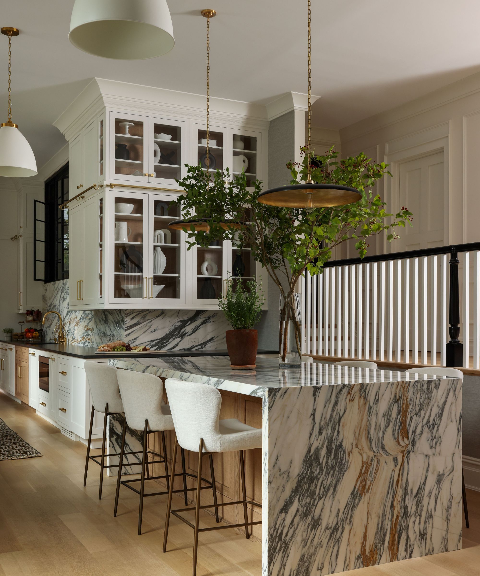 white kitchen with marble clad island white bar stools