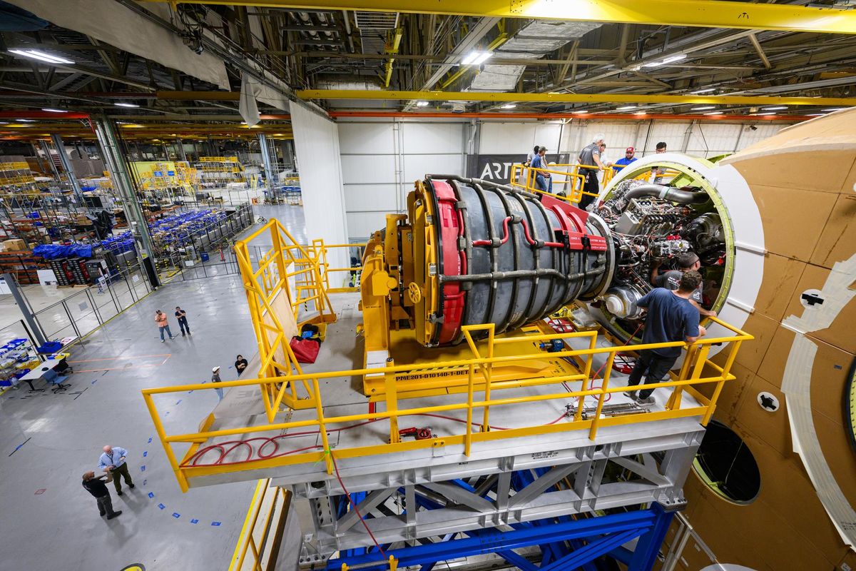 The RS-25 engine is mounted on the Artemis 2 Space Launch System rocket high above the floor of a facility at NASA's Michoud Assembly Facility in New Orleans, in September 2023.