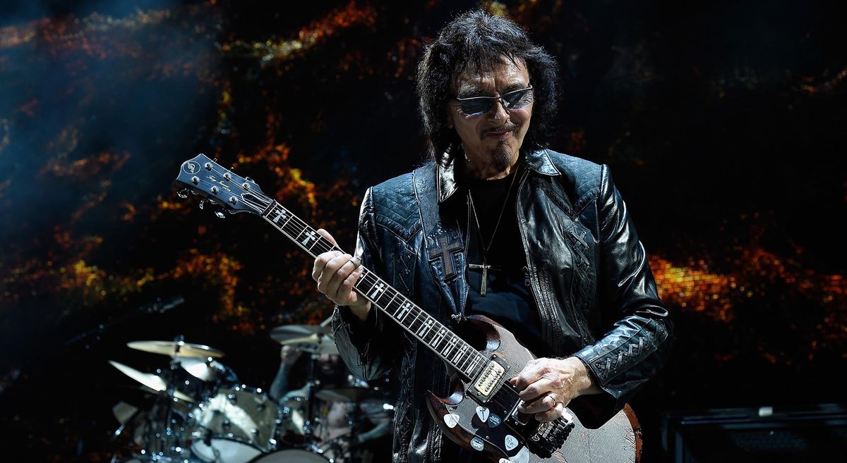 Heavy metal godfather Tony Iommi smiles as he plays another seminal riff onstage with Black Sabbath in 2016.