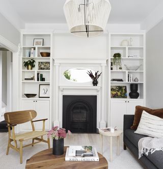 Small living room with tall shelving by Kristen Pena
