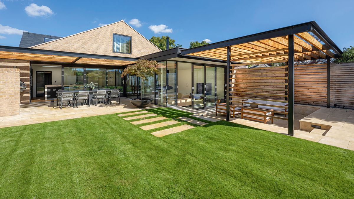 A beautifully green lawn in a modern garden with sunken patio