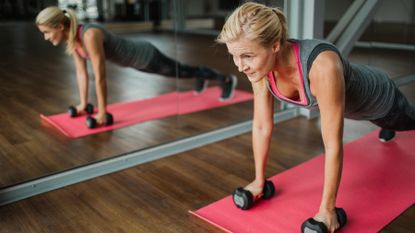 Woman works out using light dumbbells