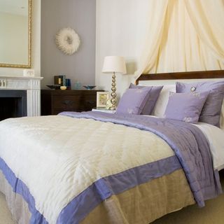 bedroom with white and blue wall bed with white and blue cushion and wooden drawer