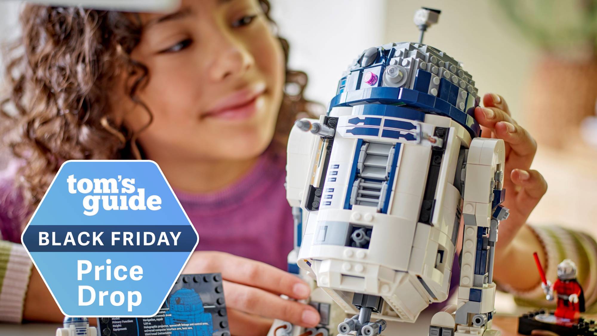 Child playing with a Lego R2-D2 building set