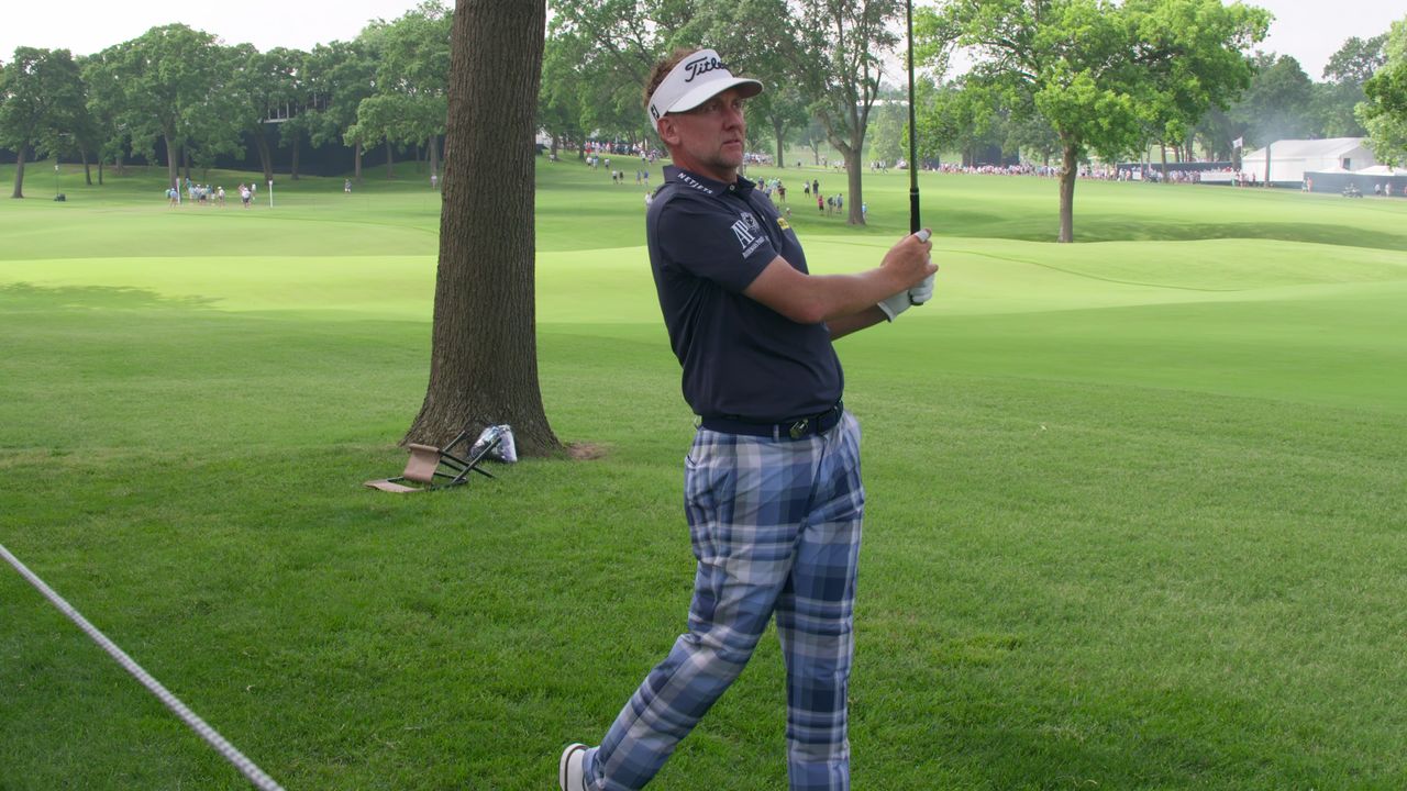 Ian Poulter looks on after hitting an iron shot