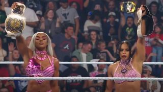 Jade and Bianca holding up their tag-team titles on SmackDown