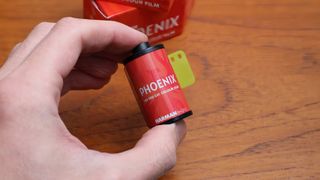 Harman Phoenix 35mm film canister held in a hand