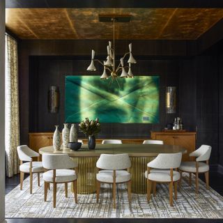 A dark-themed dining room with luxe decor