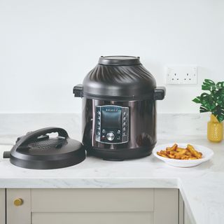 Air fryer on a kitchen counter with potato chips