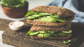 A whole grain sandwich with avocado, an example of what to eat when you're tired