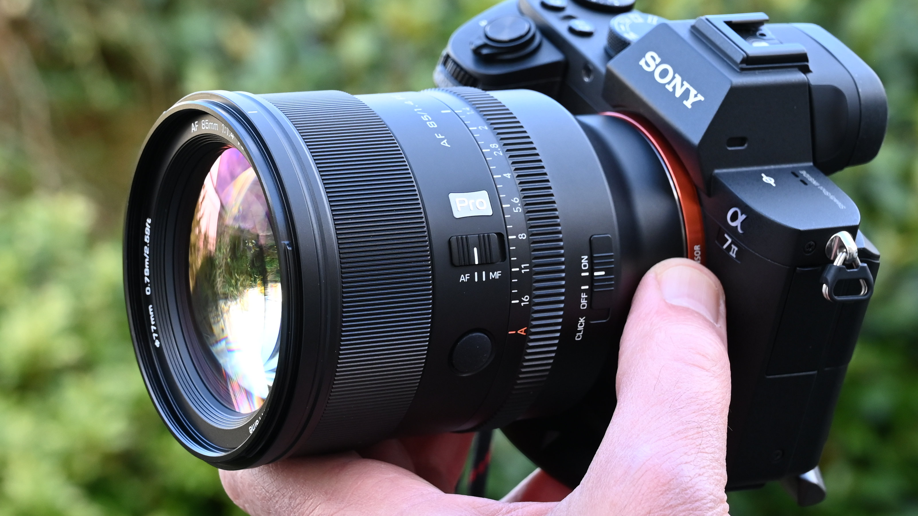 Viltrox AF 85mm f/1.4 Pro product shot, lens in hand