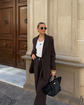 Influencer wish list 2025: @immegii wears a brown suit and Demellier tote bag