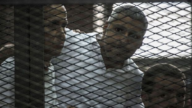 Journalists Peter Greste, Mohamed Fadel Fahmy, and Egyptian Baher Mohamed listen to the court&amp;#039;s verdict