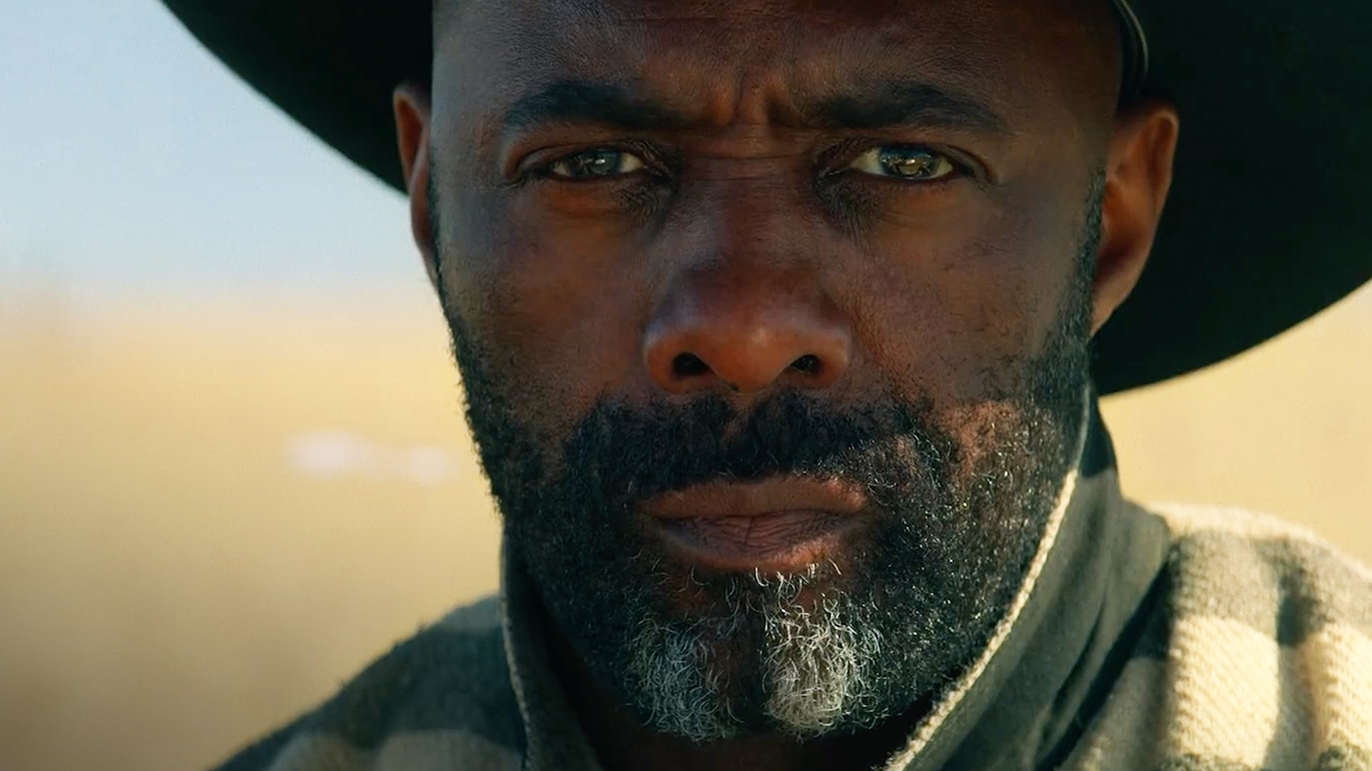 A close-up of Idris Elba as Rufus Buck in the Netflix movie, The Harder They Fall.