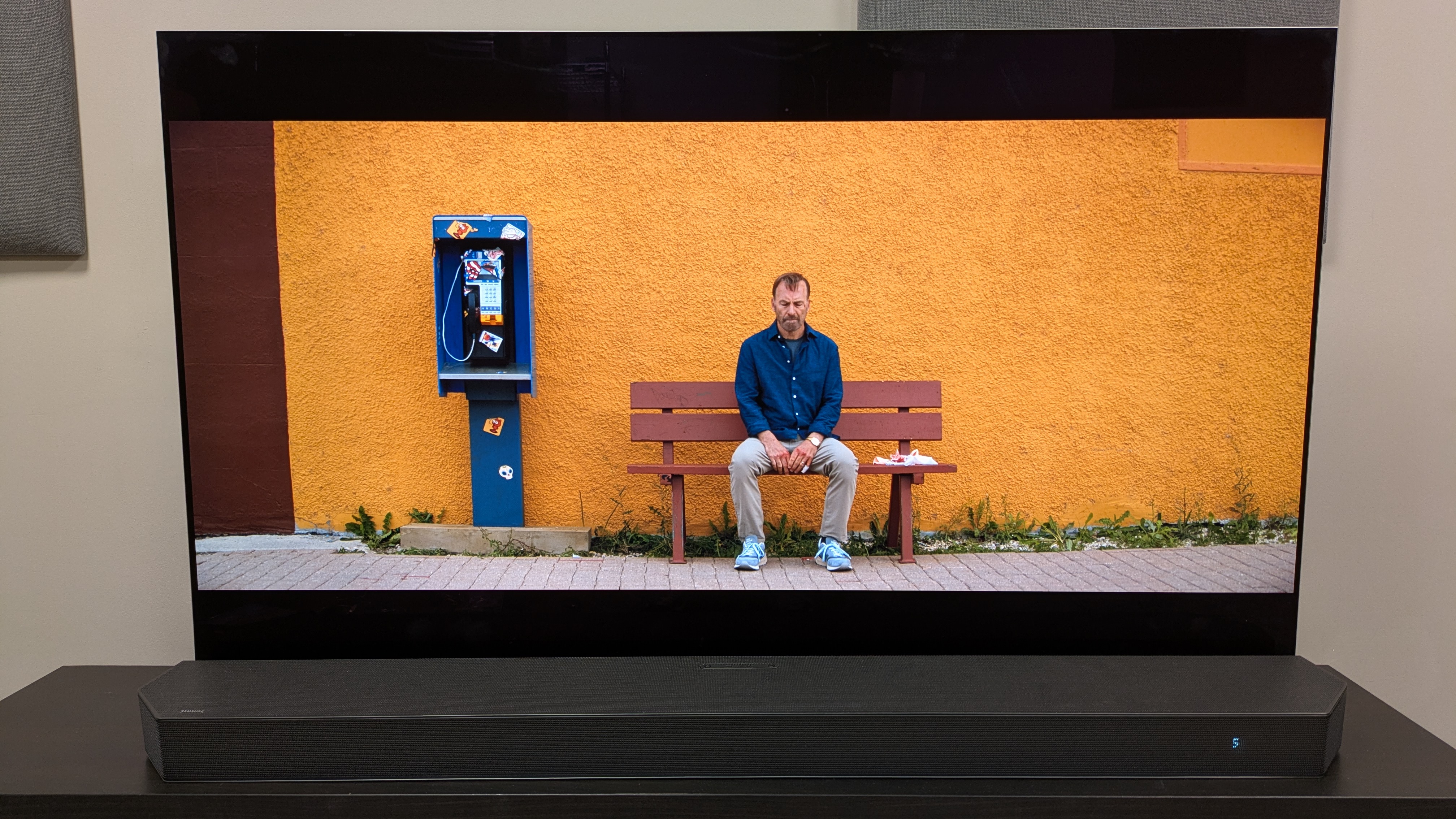 Nobody 2 4K Blu-ray showing Mansell sat on a bench in front of a yellow wall on the LG G5 