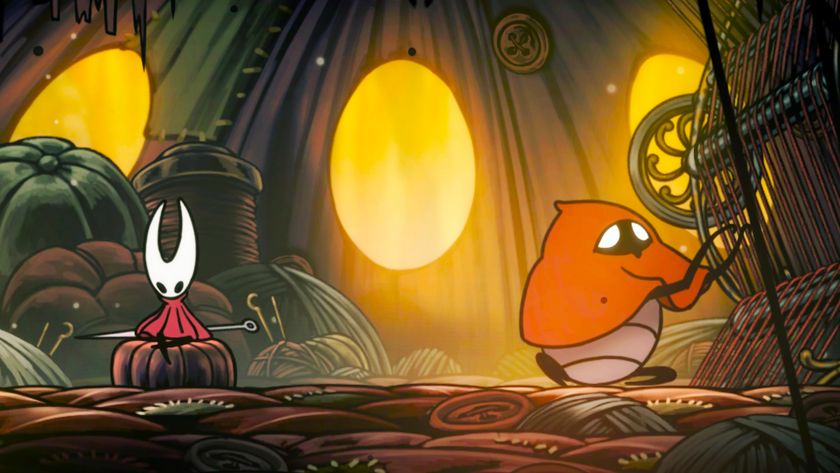 A screenshot from Hollow Knight: Silksong. An interior shot of a room with fabric, threads, and buttons on the ground. A bug-like character cloaked in red is working on a loom while the main character Hornet sits nearby.