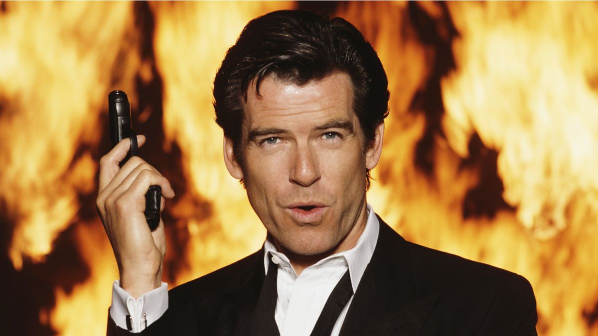 Pierce Brosnan posing with gun for James Bond film GoldenEye