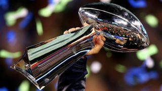 NFL Super Bowl winners hoist the Vince Lombardi Trophy