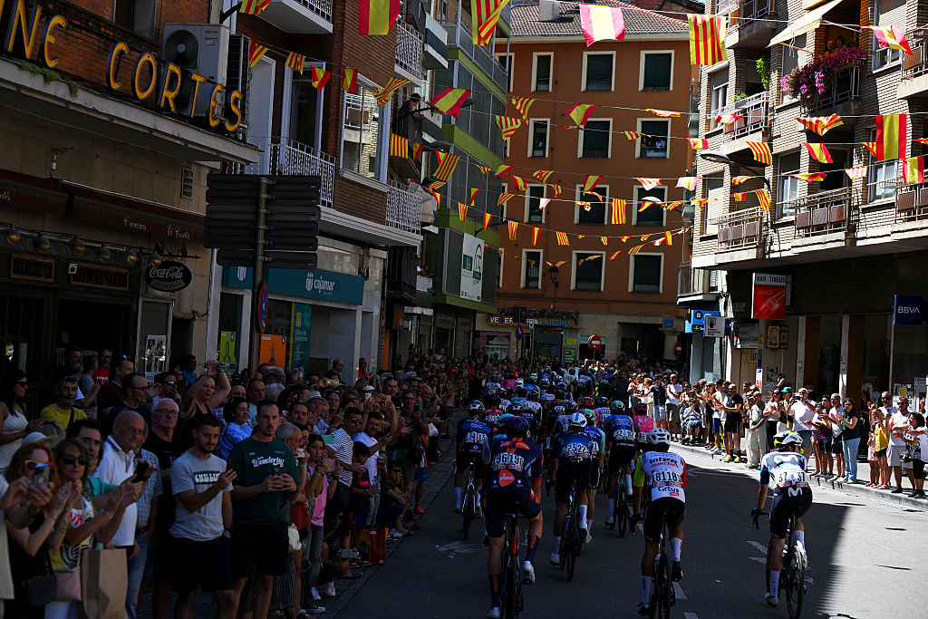 ZARAGOZA, SPAIN - AUGUST 30: A general view of the peloton passing through Barbastro city while fans cheer during the La Vuelta - 80th Tour of Spain 2025, Stage 8 a 163.5km stage from Monzon Templario to Zaragoza / #UCIWT / on August 30, 2025 in Zaragoza, Spain. (Photo by Tim de Waele/Getty Images)
