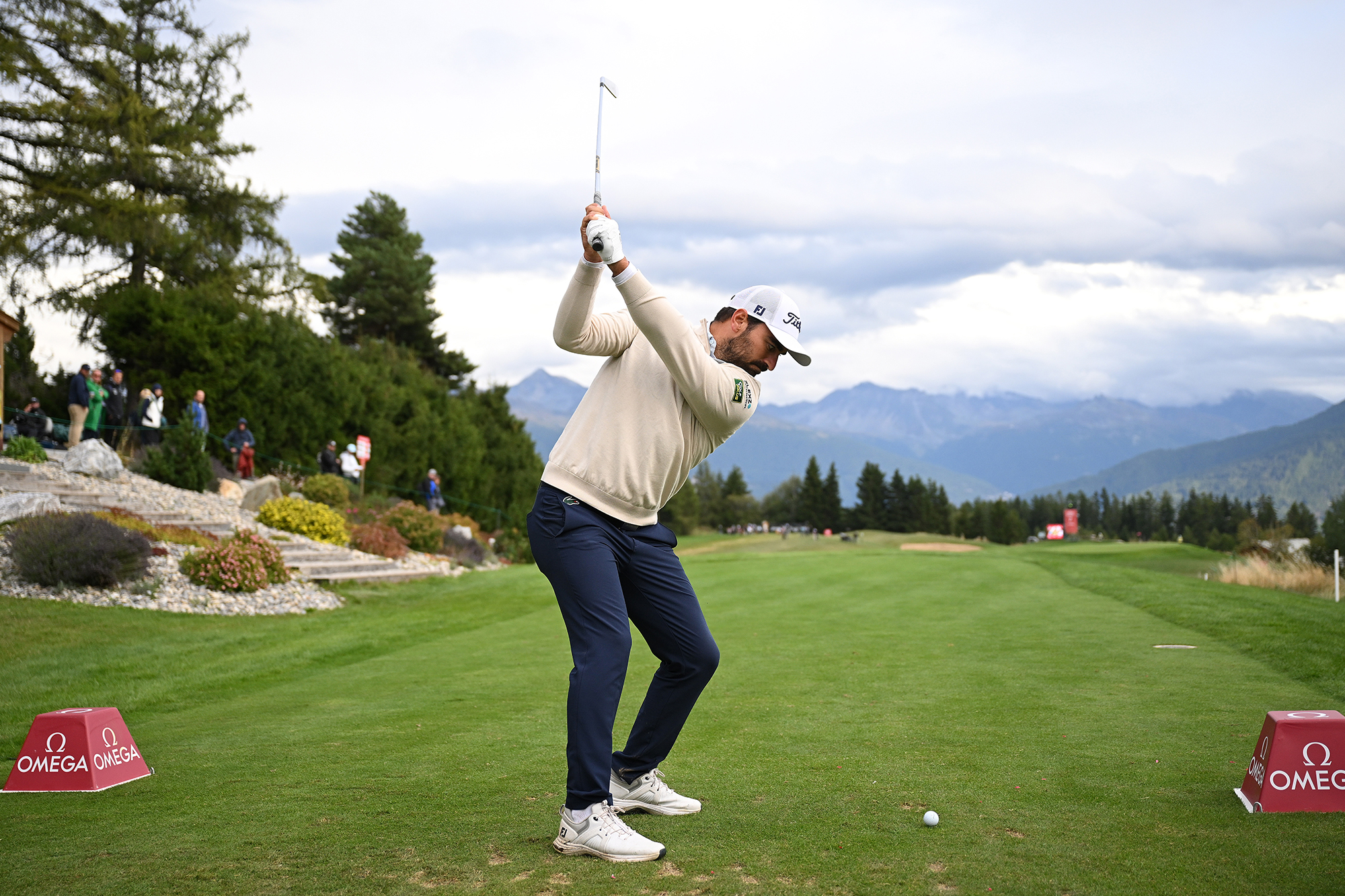 Antoine Rozner at the top of his backswing with an iron off the tee