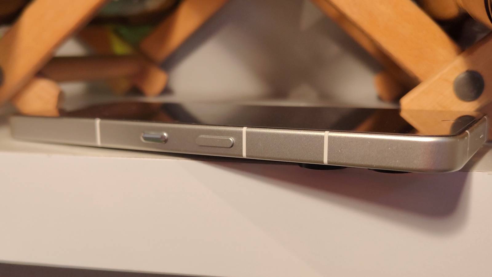 The Nothing Phone 3 on a shelf, showing its power button and Essential Key.