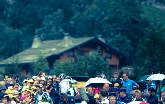 David Millar takes a drink as he rides to the team bus to catch a lift back to his hotel in Annecy.